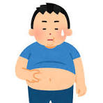 食べ過ぎてお腹を気にしている男性です。

